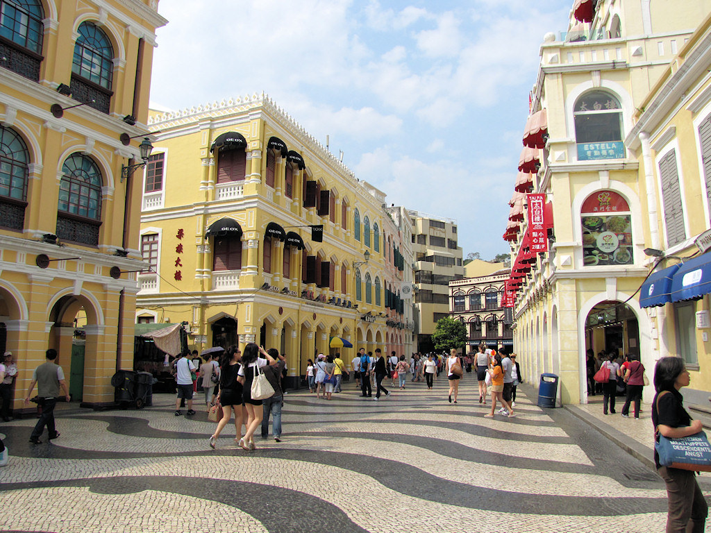 a walking street in st dominic's church in macau with kids