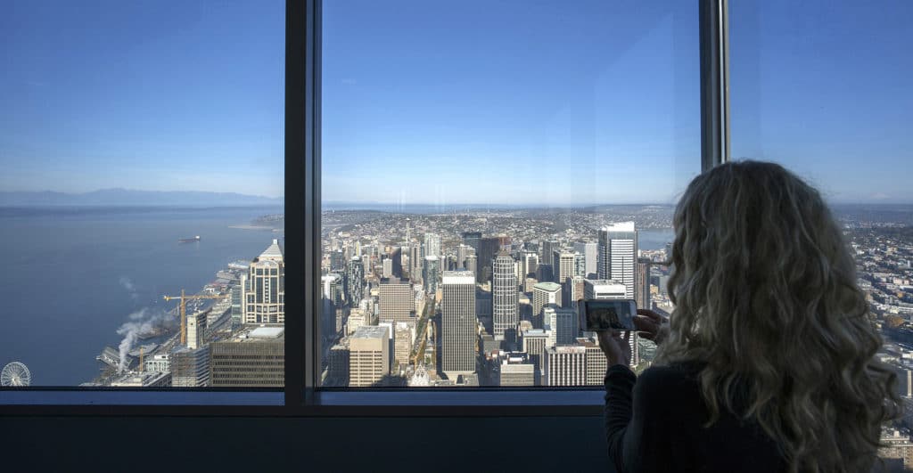 a girl is taking photos in Sky View Observatory at Columbia Tower