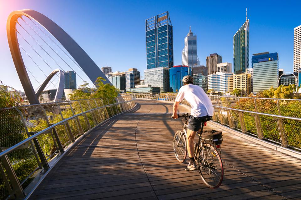 a man cycling on Elizabeth Quay bridge