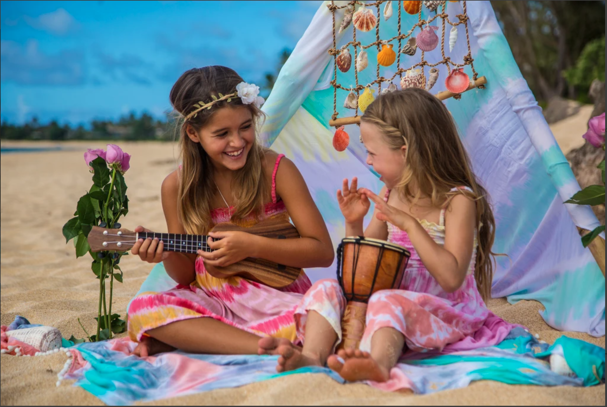 2 girls are smiling on the seaside